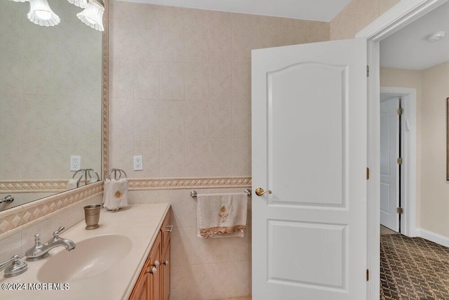 bathroom featuring vanity and tile walls