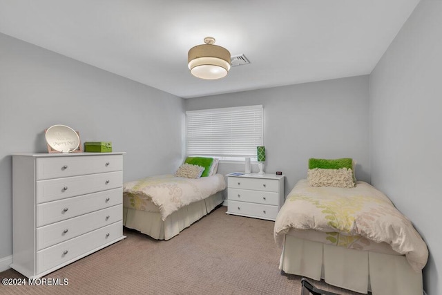 bedroom featuring light colored carpet