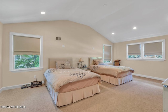 bedroom with light colored carpet and vaulted ceiling