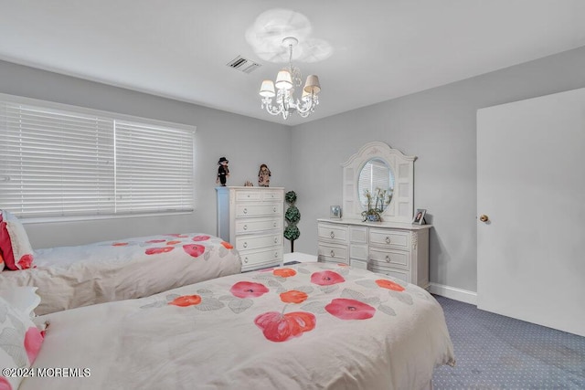 bedroom featuring carpet and a notable chandelier