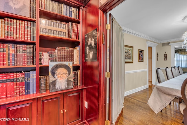 interior space with wood-type flooring and ornamental molding