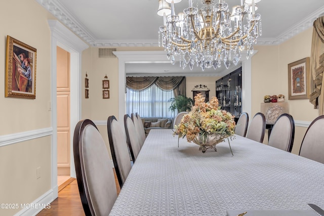 65 Chicanos Dr, Lakewood, NJ 08701 - dining room with a chandelier, wood finished floors, and crown molding