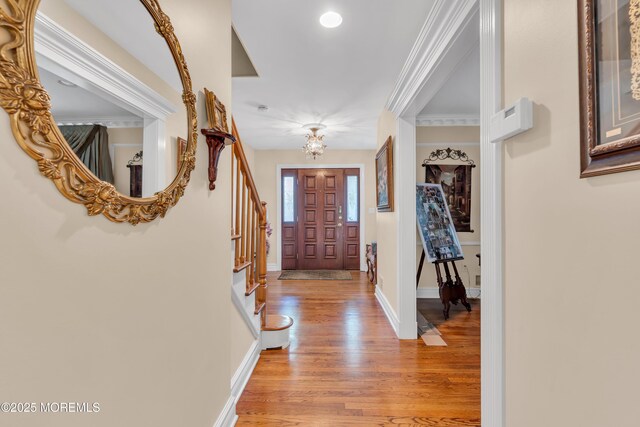 65 Chicanos Dr, Lakewood, NJ 08701 - entrance foyer with a chandelier, light wood-type flooring, stairway, and crown molding
