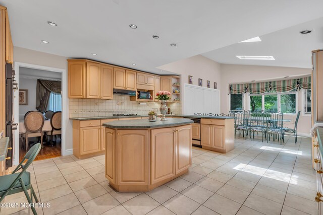 65 Chicanos Dr, Lakewood, NJ 08701 - kitchen featuring dark countertops, a kitchen island, a skylight, light tile patterned flooring, and lofted ceiling