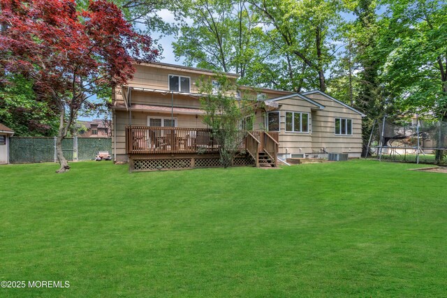 65 Chicanos Dr, Lakewood, NJ 08701 - back of house featuring a trampoline and a deck