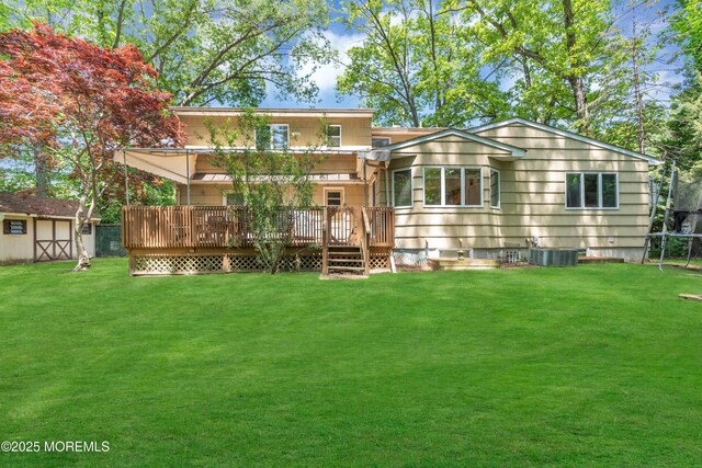 65 Chicanos Dr, Lakewood, NJ 08701 - back of house with a deck, a lawn, and an outbuilding