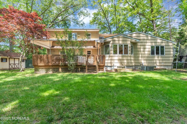 65 Chicanos Dr, Lakewood, NJ 08701 - back of house featuring a wooden deck, a yard, and a shed
