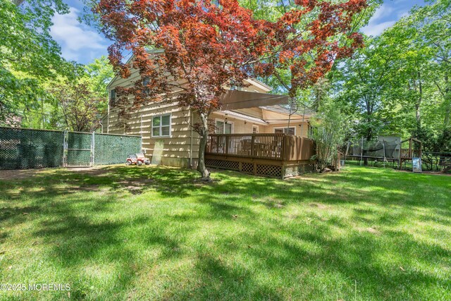 65 Chicanos Dr, Lakewood, NJ 08701 - fenced backyard with a deck