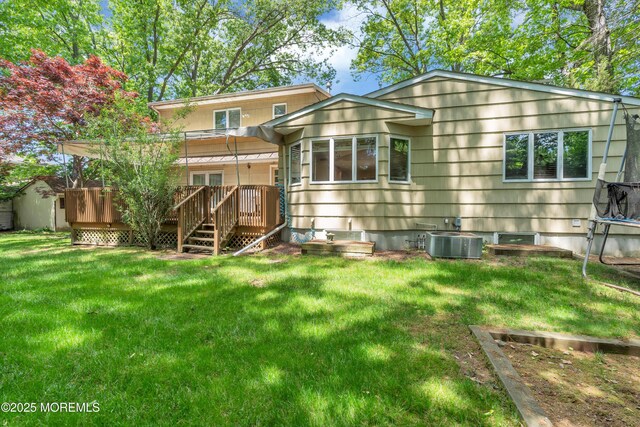 65 Chicanos Dr, Lakewood, NJ 08701 - rear view of property featuring a wooden deck and a lawn