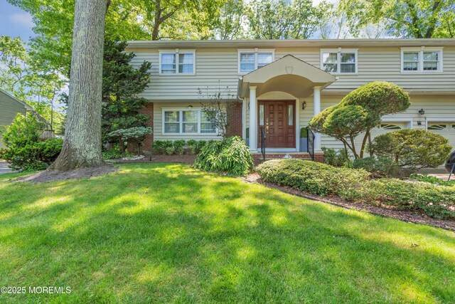 65 Chicanos Dr, Lakewood, NJ 08701 - view of front of home with brick siding and a front lawn
