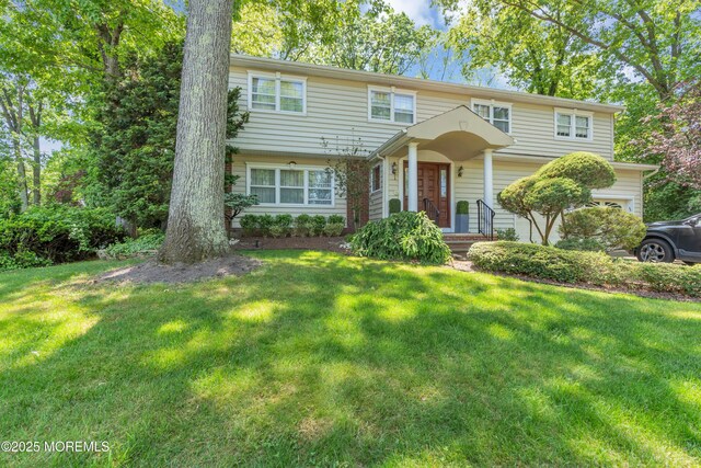 65 Chicanos Dr, Lakewood, NJ 08701 - view of front of home with a front lawn and a garage