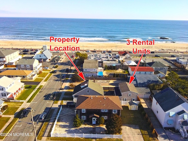 bird's eye view with a water view and a view of the beach