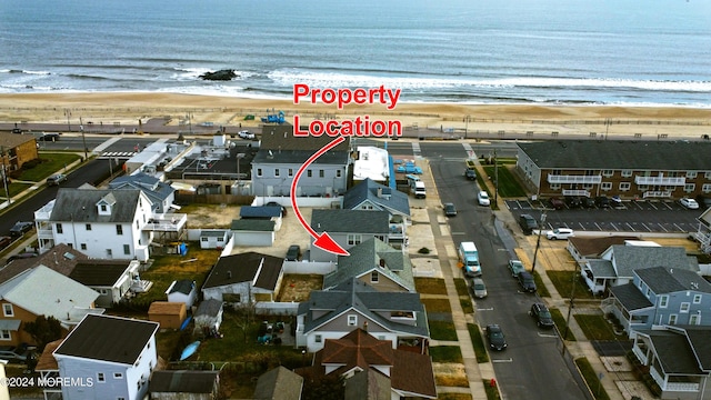 aerial view with a water view and a view of the beach