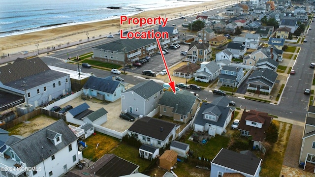 drone / aerial view with a water view and a view of the beach