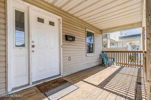 wooden terrace featuring a porch