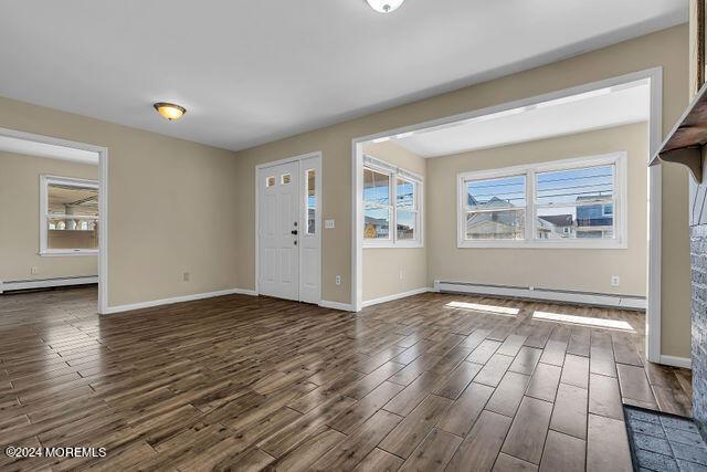 entrance foyer featuring dark hardwood / wood-style floors and a baseboard heating unit