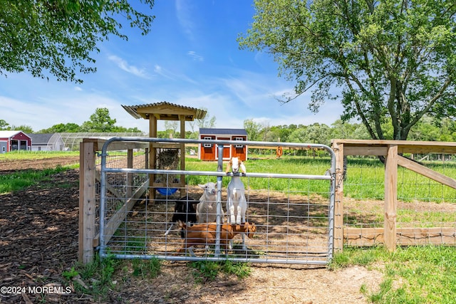 view of jungle gym with a rural view and an outdoor structure