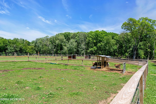 view of yard featuring a rural view and an outbuilding