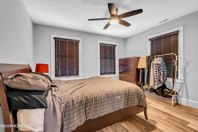 bedroom with ceiling fan and hardwood / wood-style floors