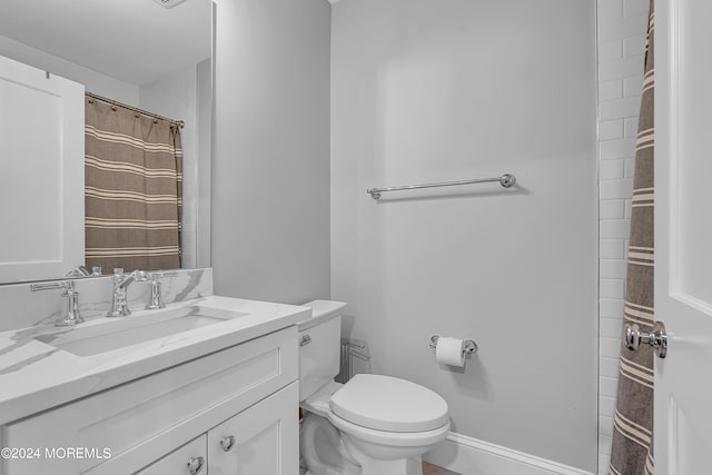 bathroom featuring toilet and vanity with extensive cabinet space