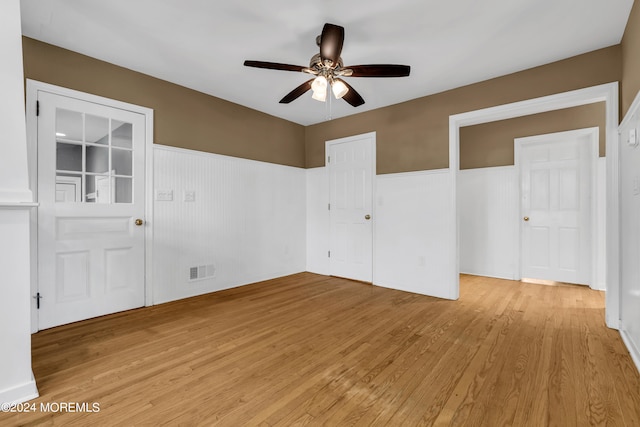 empty room featuring ceiling fan and light hardwood / wood-style floors