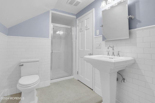 bathroom featuring tile walls, walk in shower, tile flooring, and lofted ceiling