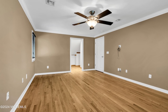 spare room featuring ceiling fan, ornamental molding, and light hardwood / wood-style floors