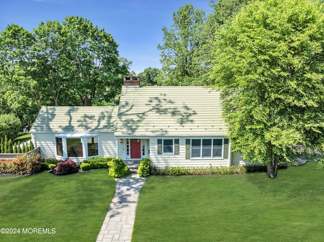 cape cod home with a front yard