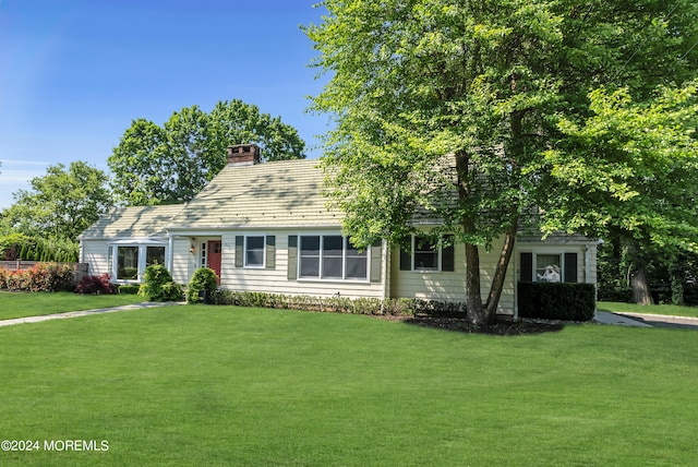 cape cod-style house with a front lawn