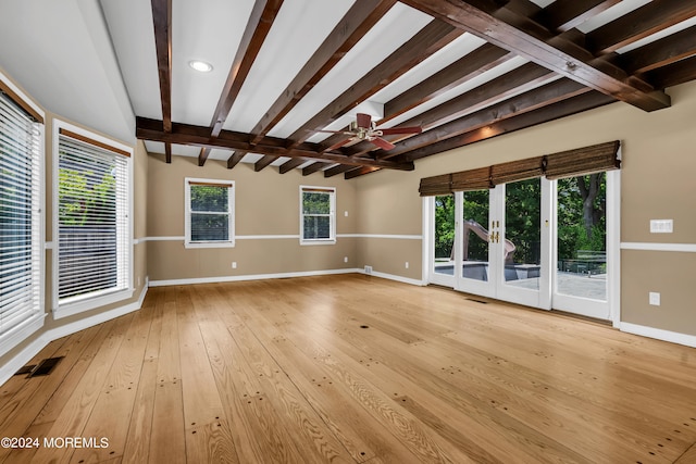 unfurnished room featuring ceiling fan, beam ceiling, and light hardwood / wood-style floors