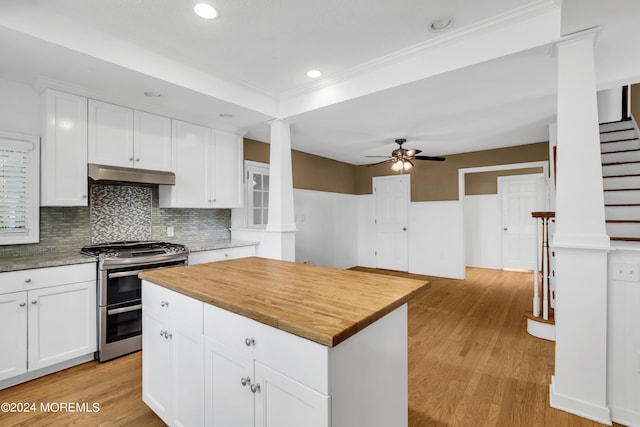 kitchen featuring light hardwood / wood-style flooring, ceiling fan, tasteful backsplash, white cabinetry, and double oven range