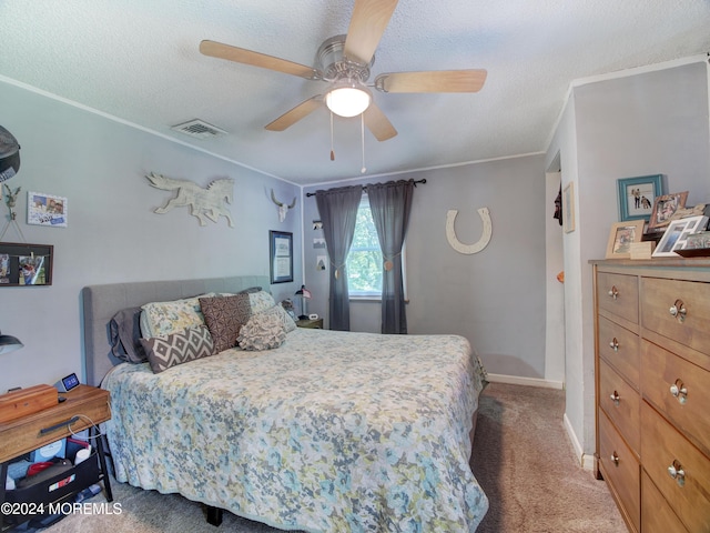 carpeted bedroom with ceiling fan and a textured ceiling