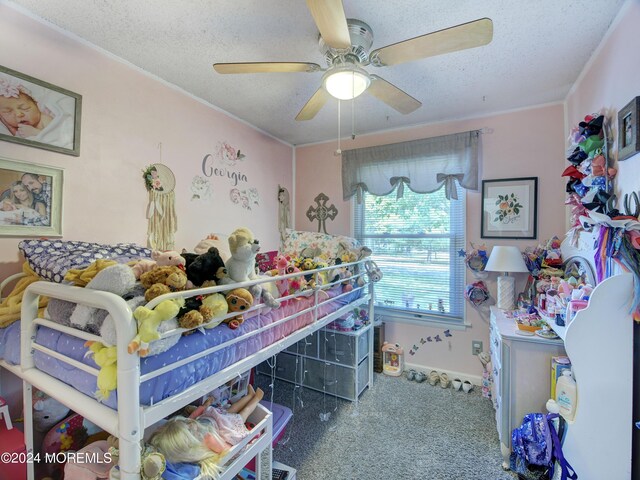 carpeted bedroom featuring ceiling fan and a textured ceiling