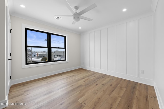 empty room featuring ornamental molding, light hardwood / wood-style flooring, and ceiling fan