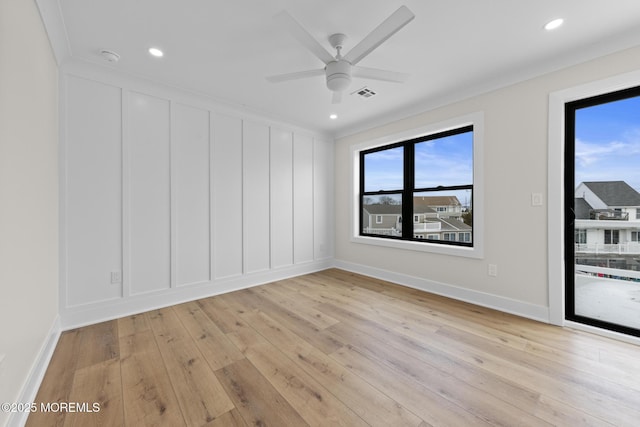 unfurnished room with crown molding, ceiling fan, and light hardwood / wood-style flooring