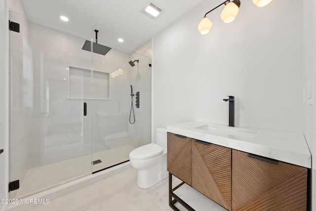 bathroom featuring toilet, a shower with door, tile patterned flooring, and vanity