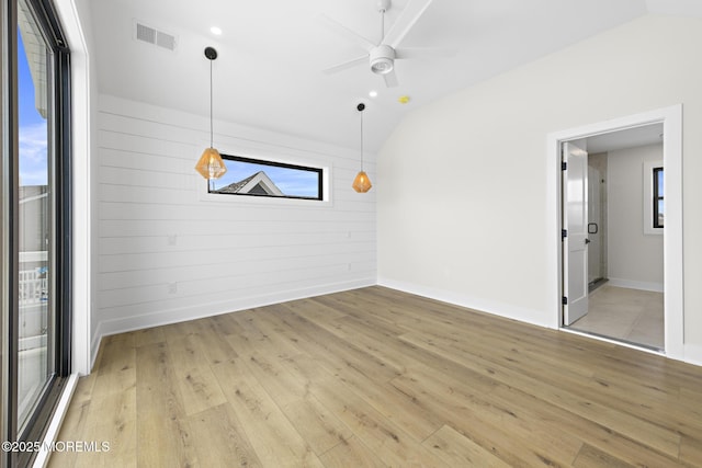 unfurnished room with light wood-type flooring, lofted ceiling, and ceiling fan