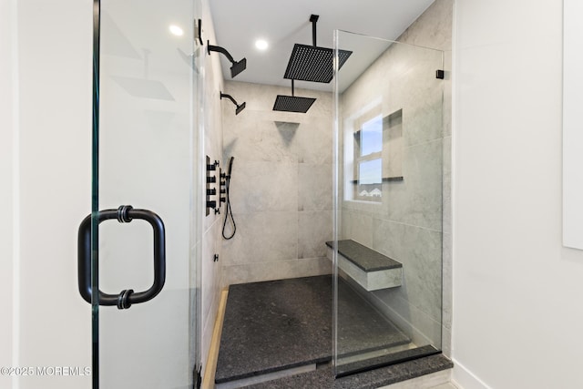 bathroom featuring a shower with door