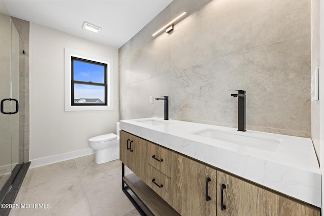 bathroom with a shower with door, tile patterned floors, toilet, tile walls, and vanity