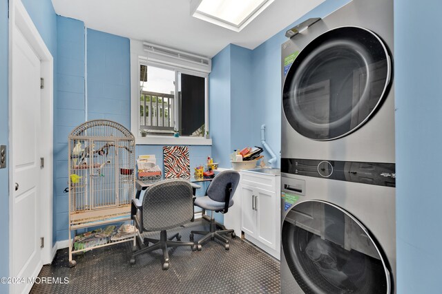 interior space featuring cabinets and stacked washing maching and dryer