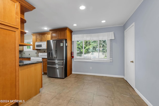 kitchen featuring dark stone countertops, white appliances, backsplash, and ornamental molding