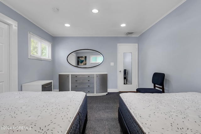 bedroom featuring crown molding and dark carpet