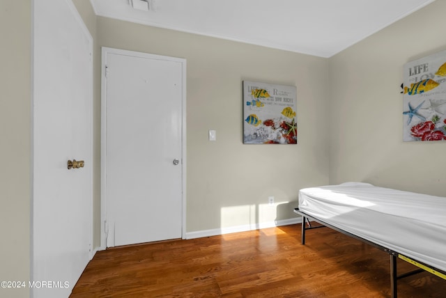 bedroom with hardwood / wood-style floors