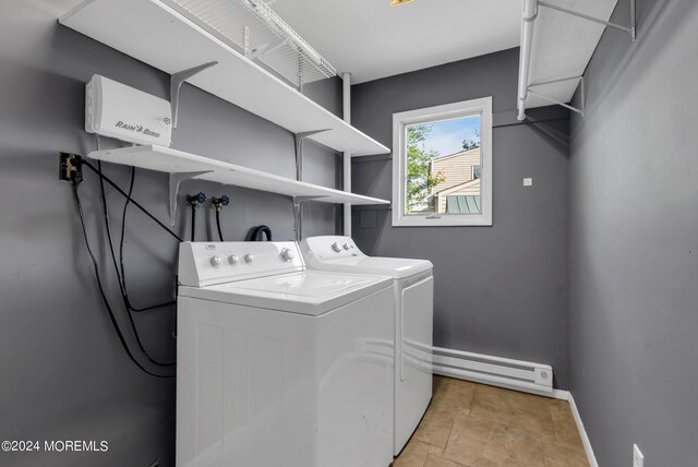 laundry room featuring washer and dryer and a baseboard heating unit