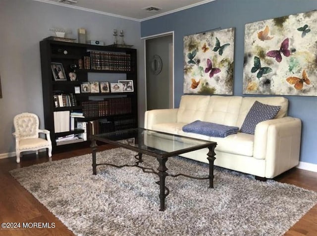 living room with hardwood / wood-style floors and ornamental molding