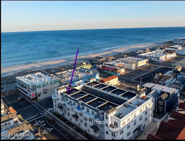 aerial view with a water view and a beach view