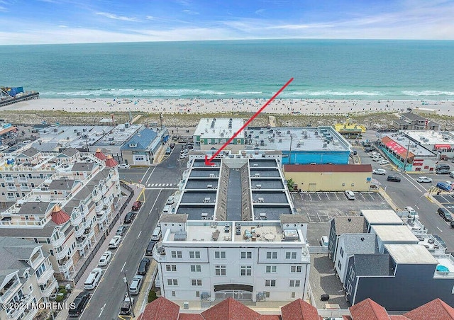 drone / aerial view with a view of the beach and a water view