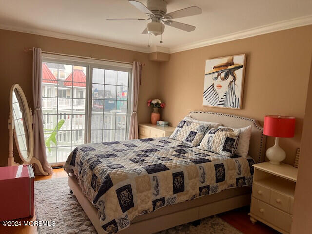 bedroom with ornamental molding, ceiling fan, and dark hardwood / wood-style floors