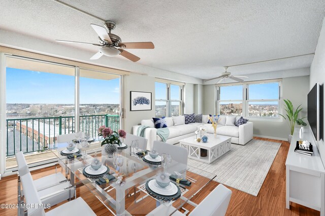 interior space featuring ceiling fan, plenty of natural light, a textured ceiling, and hardwood / wood-style floors