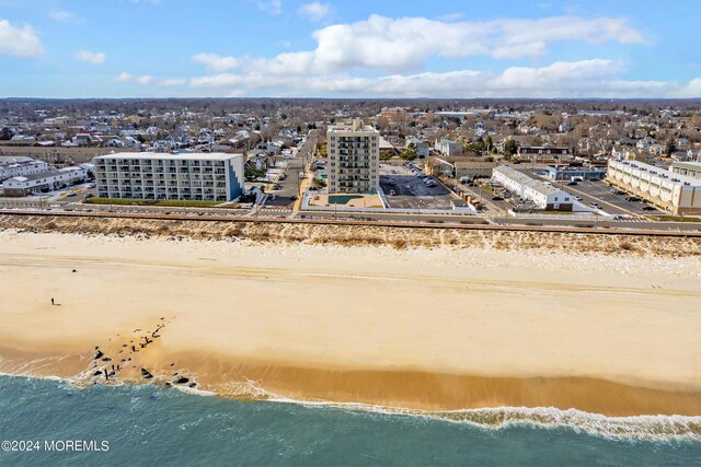 aerial view featuring a view of the beach and a water view